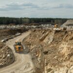 Mining truck moving down road along building area